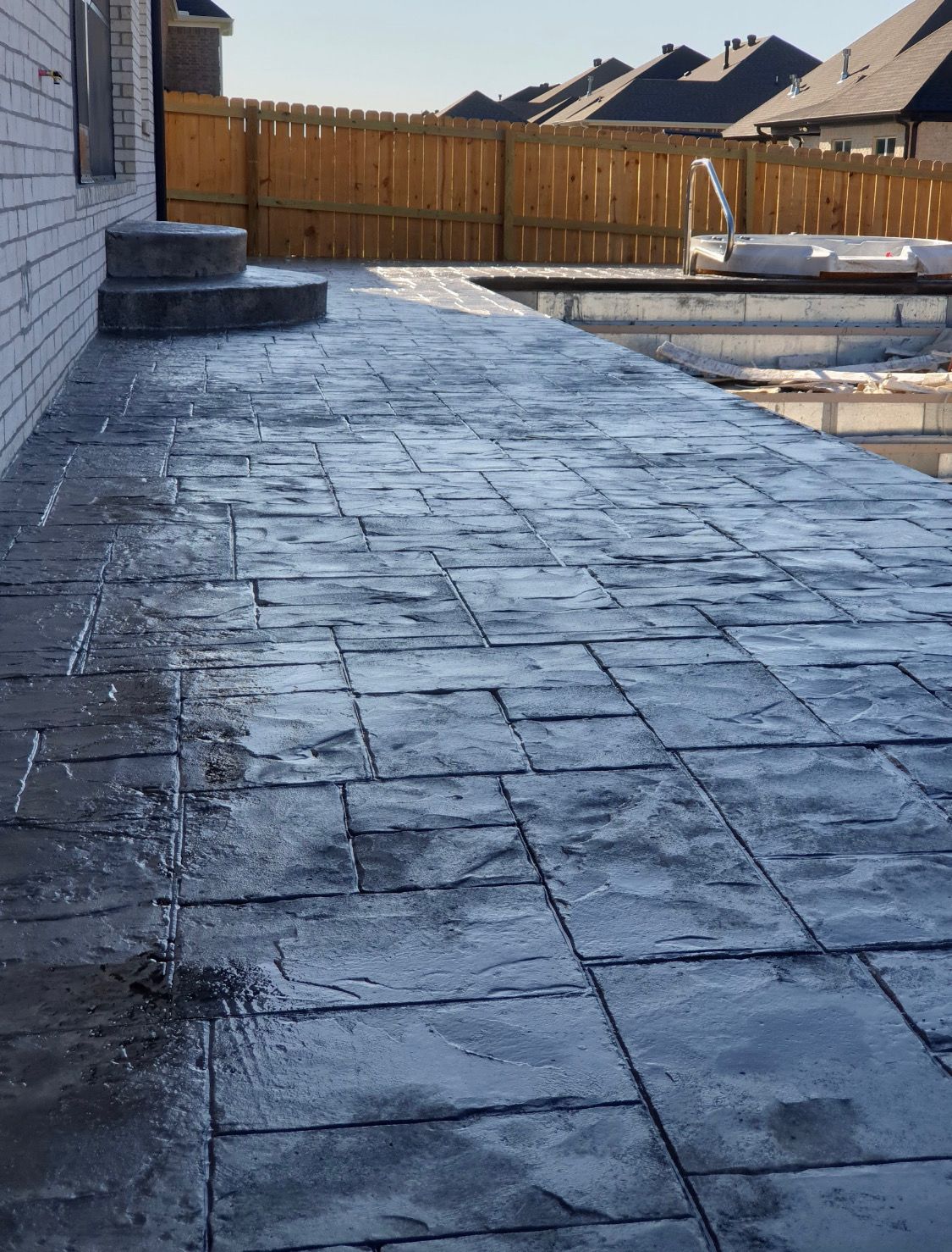 Dark stained stamped concrete patio in Cabot, AR